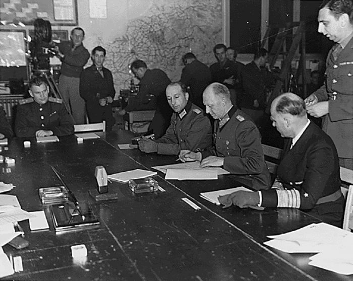 Colonel General Alfred Jodl, previously authorised to do so by Karl Dönitz, signed the unconditional surrender of the Wehrmacht to the Western Allies in Reims on 7 May 1945, which came into force on 8 May.